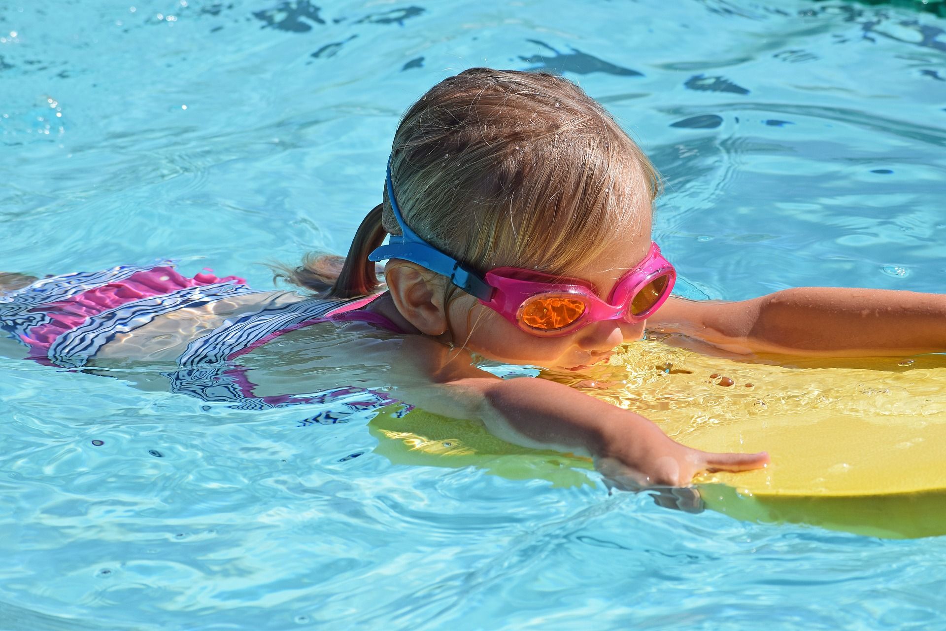 chica-nadando-con-tabla-en-piscina